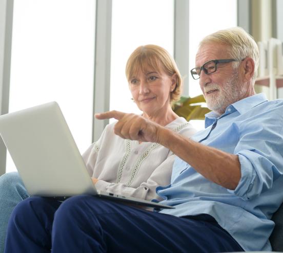 Senior couple using a laptop together