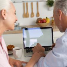 back-view-picture-mature-loving-couple-family-using-laptop