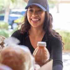 woman delivering meals to a home