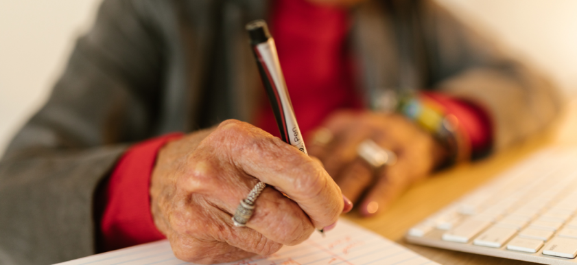 senior writing with a sharpie marker pen on lined notebook paper