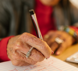 senior writing with a sharpie marker pen on lined notebook paper