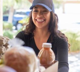 woman delivering meals to a home